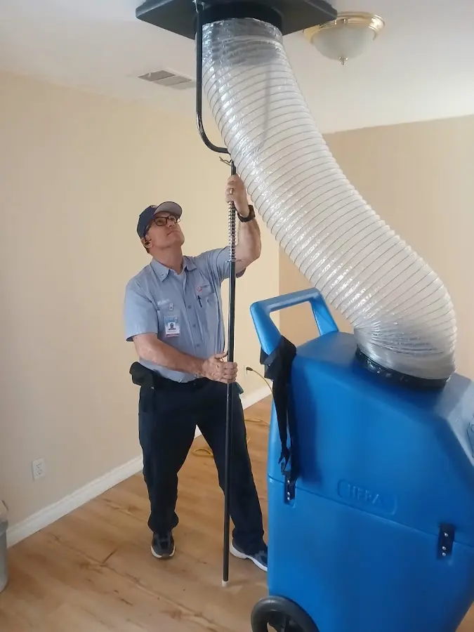 Furnace Tune-Up technician using HEPA equipment in Crosspointe